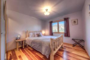 a bedroom with a large bed and a window at Stunning 360° Views - Hiker's Paradise! in Cascade-Chipita Park