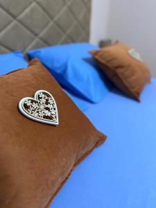 a heart patch on a pillow on a bed at Aquata Apartments in Tivat