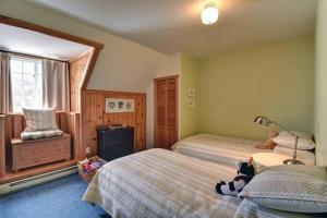 1 dormitorio con 2 camas y un animal de peluche en la cama en Country cottage on the banks of the Red River, en La Conception