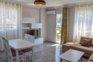 a living room with a table and a couch at Gimi Apartments Shengjin in Shëngjin