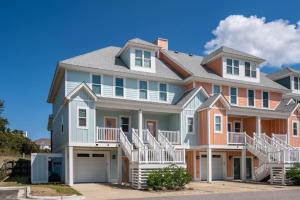 a large house with orange and white at Cambridge Reserve by KEES Vacations in Kill Devil Hills