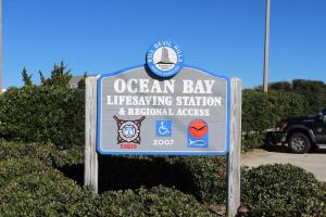 a sign for an ocean bay interviewing station and regional agencies at Cambridge Reserve by KEES Vacations in Kill Devil Hills