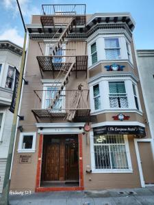 a tall building with a fire escape ladder on it at European Hostel in San Francisco
