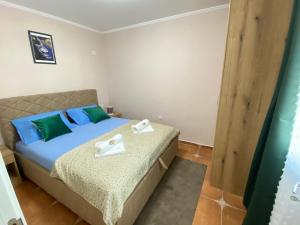 a bedroom with a bed with towels on it at Aquata Apartments in Tivat