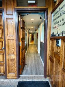 a hallway in a building with wooden doors at European Hostel in San Francisco