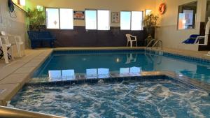 a large swimming pool with chairs in it at Comfort Inn Garden City in Garden City