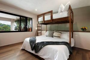 a bedroom with two bunk beds and a window at Hermosa Villa Vista al Lago in Valle de Bravo +23 photos