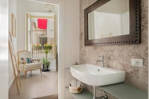 a bathroom with a sink and a mirror at Palazzo Ventimiglia in Palermo