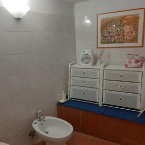 a bathroom with a sink and a white toilet at In Vacanza a Gaeta - MariNella in Gaeta