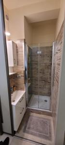 a bathroom with a shower with a glass door at Basilica Apartments in Budapest