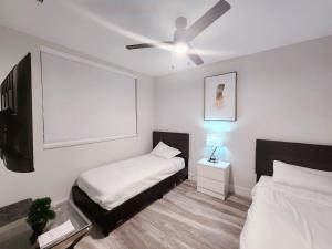 a bedroom with a bed and a ceiling fan at Lux property great for 1 to 8 Guests-family trip ,5Beds 2Rooms Staycation with Gym and EV, proximity to Downtown and Beaches in West Palm Beach