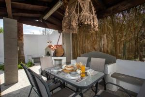 a dining table and chairs on a patio at Hriska Luxury Villa in Ixia