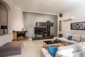 a living room with a couch and a fireplace at Hriska Luxury Villa in Ixia