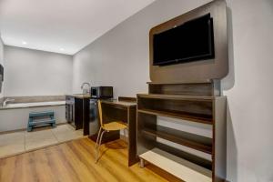 a living room with a tv on a wall at Motel 6-La Mesa, CA in San Diego