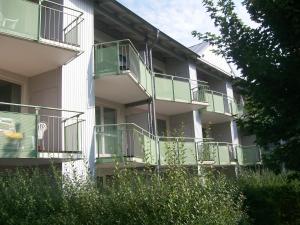 an apartment building with green balconies on the side of it at Parkresidenz Sanssouci in Zinnowitz