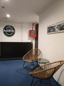 a meeting room with two chairs and a table at AeCOTEL in Sandakan