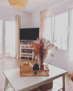 a table with a basket of flowers on top of it at Casa Rosalia Puerto del Carmen in Puerto del Carmen +26 photos