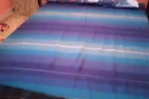 a close up of a bed with blue sheets at منزل فاخر مفروش للكراء بتارودانت in Taroudant