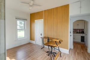 a kitchen with a wooden table in a room at Cedar Rapids Vacation Home Near Downtown District! in Cedar Rapids