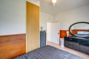 a bedroom with a bed and a large mirror at Cedar Rapids Vacation Home Near Downtown District! in Cedar Rapids