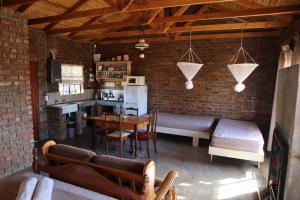 a kitchen and living room with a table and chairs at Wolvekraal Guest Farm in Prince Albert