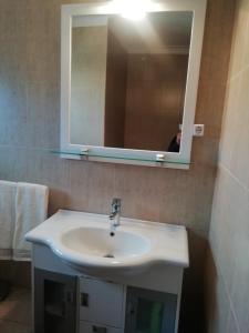 a bathroom with a white sink and a mirror at Alojamento Local Casa Veras in Vila Real