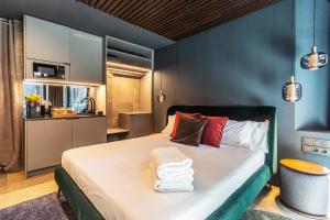 a bedroom with a bed with towels on it at LUXURY EVOLUTION ROOMS in Alicante