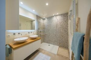 a bathroom with two sinks and a shower at Maison Lily by Exclusive-Stays in Knokke-Heist +11 photos