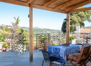 a table and chairs on a patio with a view at Cozy studio in Dafnes near to Heraklion in Dhafnés