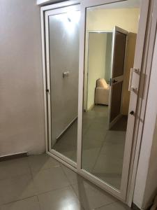 a sliding glass door in a room with a mirror at Appart F2 plein centre in Klétigan +11 photos