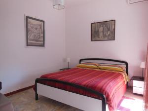 a bedroom with a bed with a colorful blanket on it at Casa Sista in Lido di Ostia