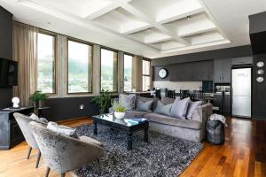 a living room with a couch and a table at #1701 Cartwright - Dark Glamour in Cape Town