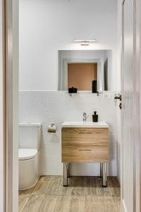 a bathroom with a sink and a toilet at ARI Central Grand Apartment in Arad