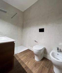 a bathroom with a toilet and a sink at Alèa Rooms in Lecce