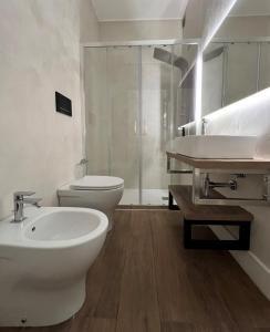a bathroom with a sink and a toilet and a shower at Alèa Rooms in Lecce
