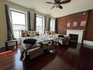 a living room with a bed and a fireplace at Downtown Loft Sleeps 6 - Pool Table Shuffleboard in Louisville