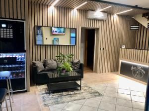 a living room with a couch and a table at Hostal San Martin in San Martín de la Vega