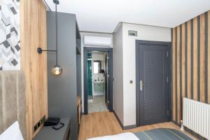 a bedroom with a door leading to a bathroom at Heaven Inn Airport Hotel in Arnavutköy