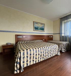 una camera d'albergo con due letti e una finestra di Viole Country Hotel ad Assisi