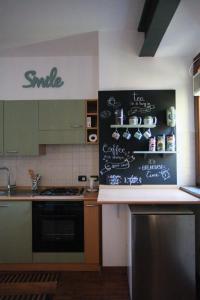 a kitchen with a chalkboard on the wall at Zen House in Cormano