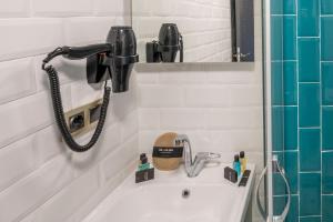 a bathroom with a sink and a phone on the wall at Heaven Inn Airport Hotel in Arnavutköy +37 photos
