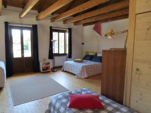 a living room with two beds and a door at Appartamento AQUILONE in Mergozzo