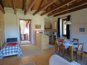 a living room with a dining table and a kitchen at Appartamento AQUILONE in Mergozzo