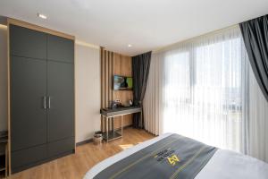 a bedroom with a bed and a large window at Heaven Inn Airport Hotel in Arnavutköy