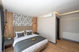 a bedroom with a large bed in a room at Heaven Inn Airport Hotel in Arnavutköy