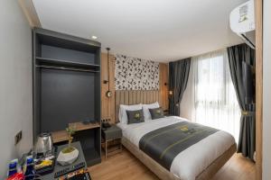 a hotel room with a large bed and a window at Heaven Inn Airport Hotel in Arnavutköy