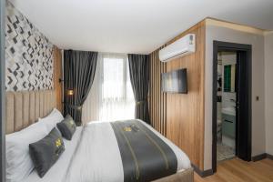 a bedroom with a large bed and a window at Heaven Inn Airport Hotel in Arnavutköy