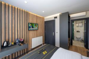 a hotel room with a bed and a bathroom at Heaven Inn Airport Hotel in Arnavutköy
