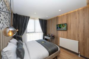 a bedroom with a large bed and a window at Heaven Inn Airport Hotel in Arnavutköy