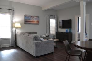 a living room with a couch and a table at The Lofts at GFC in Galveston